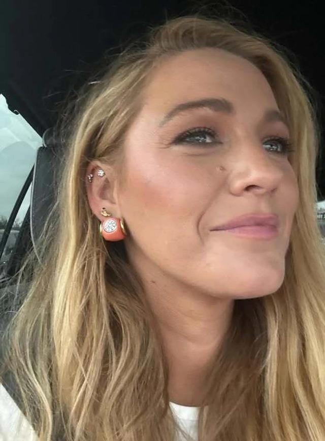 Blake Lively shares a casual selfie, showcasing her radiant smile and stylish earrings.